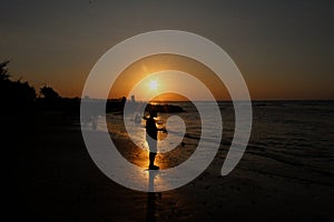Silhouette on the beach at sunset