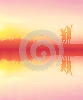 silhouette children playing happy time at sunset with water reflection