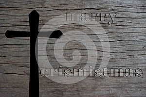 Silhouette of Christian cross on old wood background