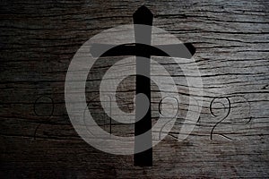 Silhouette of Christian cross on old wood background