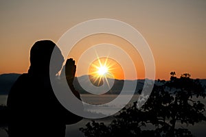 Silhouette of christian man hand praying,spirituality and religion,man praying to god.