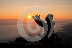 Silhouette of christian man hand praying,spirituality and religion,man praying to god