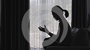 Silhouette of christian woman hand praying, spirituality and religion, woman praying to god. Christianity concept. Freedom and