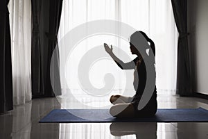 Silhouette of christian young woman praying, Christian Religion concept background