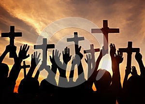 Silhouette of Christians holding crosses