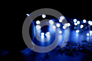 Silhouette of Christmas ball and snowflake on the floor on blurred background of lights