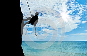 Silhouette climber climbing a mountain