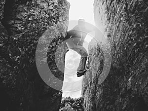 Silhouette of climber in crevasse in black and white photo