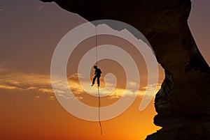 Silhouette of a climber over beautiful sunset