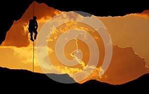 Silhouette of a climber over beautiful sunset