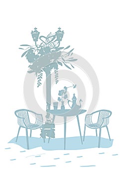 Silhouette of a coffee table with cups and a coffee pot with a lantern and flowers.