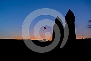 Silhouette colorful hot air balloons flying over fairy chimneys, Cappadocia, Turkey.