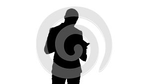 Silhouette Concentrated businessman reading financial report