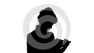 Silhouette Concentrated young business woman holding and reading book track matte