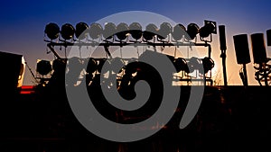 Silhouette of Concert Stage with Blue Sky and Sun Background