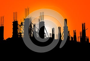 Silhouette of construction on industry site at concept sunrise time with sun light effect background with copy space add text