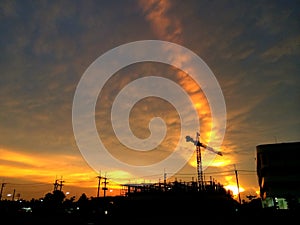 The Silhouette of construction site under sunset.