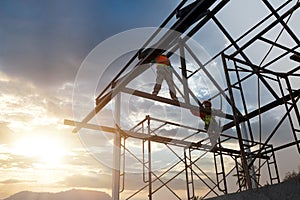 Silhouette of construction worker on roof structure in construction site, concept Safety height equipment