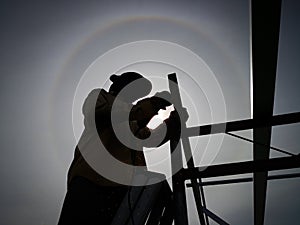 Silhouette of a construction worker working under hot sun