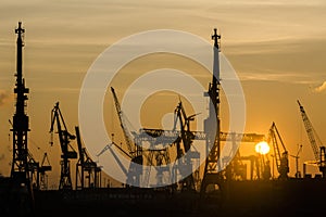 Silhouette of container harbor in Hamburg at sunset