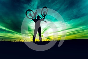 Silhouette, contour of byciclist rising bike and celebrating. Action of succesful people winning contest