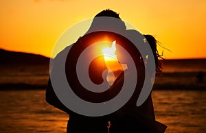 Silhouette couple, beach sunset and love outdoors on summer vacation, honeymoon travel and tropical holiday in Maldives