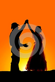 Silhouette couple dance spin