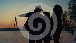 Silhouette couple daughter enjoy river sunset lear sky. Caring people together.