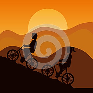 Silhouette of couple driving bike climbing mountain with sky at sunset