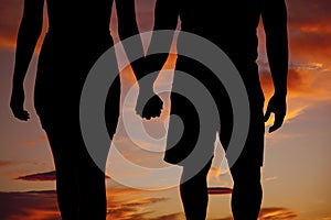 Silhouette couple holding hands