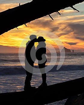 Silhouette of a couple kissing at the beach during a beautiful sunset. Olympic National Park, Washington