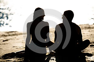 Silhouette of a couple in love on the beach at sunset.Love story.Man and a woman on the beach