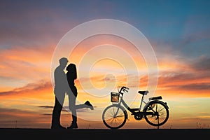 Silhouette of couple in love kissing in sunset. Couple in love c