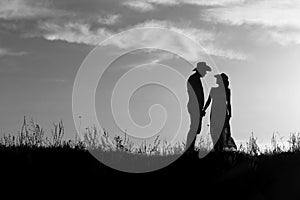 Silhouette of a couple in love at sunset
