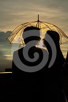 Silhouette couple prewedding under umbrella