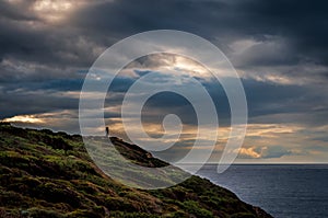 Silhouette of couple staring at the coast in winter