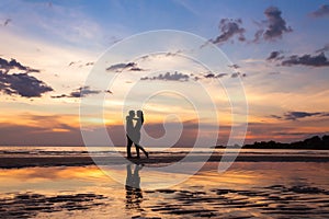 Silhouette of couple on sunset beach