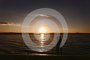 Silhouette couples in the sea at sunset