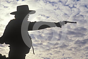 Silhouette of Cowboy aiming pistol