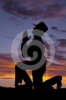 Silhouette cowboy kneel head up