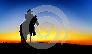 Cowboy on a horse at sunset. silhouette