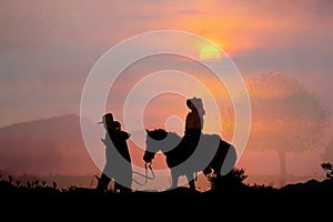 Silhouette of the cowboy and the setting sun