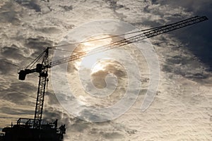 Silhouette crane construction site on sunset background