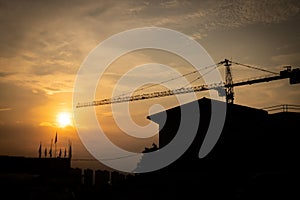 Silhouette crane construction site on sunset time background