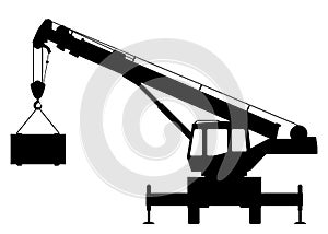 Silhouette of a crane lifting a load.
