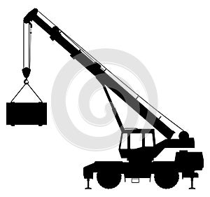 Silhouette of a crane lifting a load.
