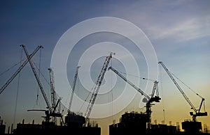 Silhouette crane working in construction site