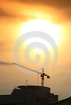 Silhouette cranes on construction site