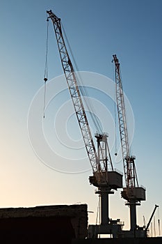 Silhouette of Cranes at Work in Boatyard