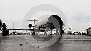 Silhouette of CRJ-1000 bombardier aircraft in hangar on front side
